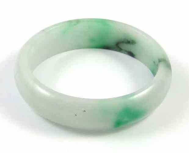 Appraisal: HEAVY GREEN JADE BANGLE round in shape having shades of