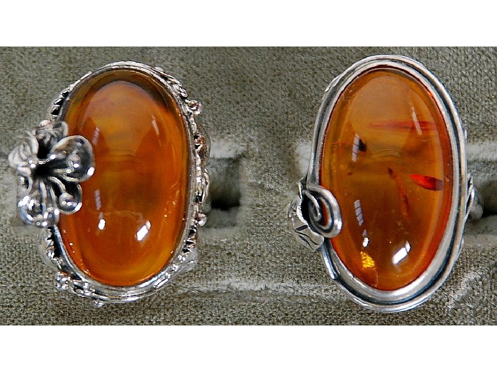 Appraisal: TWO SILVER AND LARGE CABOCHON OVAL GOLDEN AMBER RINGS one