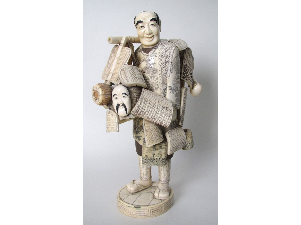 Appraisal: A Chinese carved sectional ivory figure of a street vendor