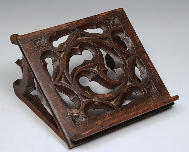 Appraisal: A GOTHIC OAK FOLDING BOOK STAND with foliate scroll decoration