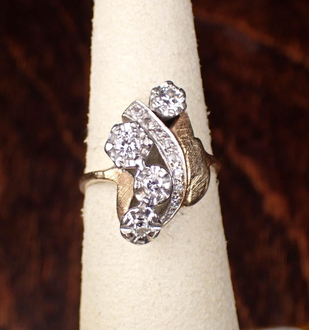 Appraisal: DIAMOND AND FOURTEEN KARAT TWO-TONE GOLD RING The yellow and