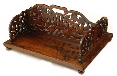 Appraisal: A Victorian rosewood double sided book tray with pierced foliage