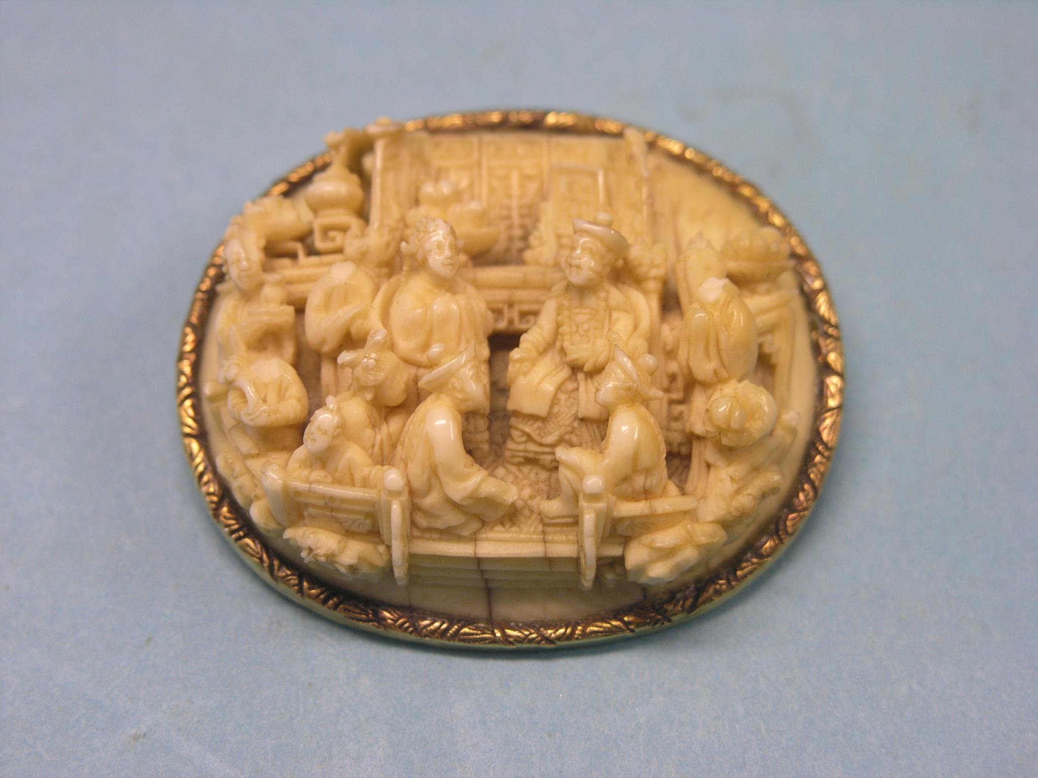 Appraisal: A Canton ivory brooch oval-shape within engraved yellow metal mount