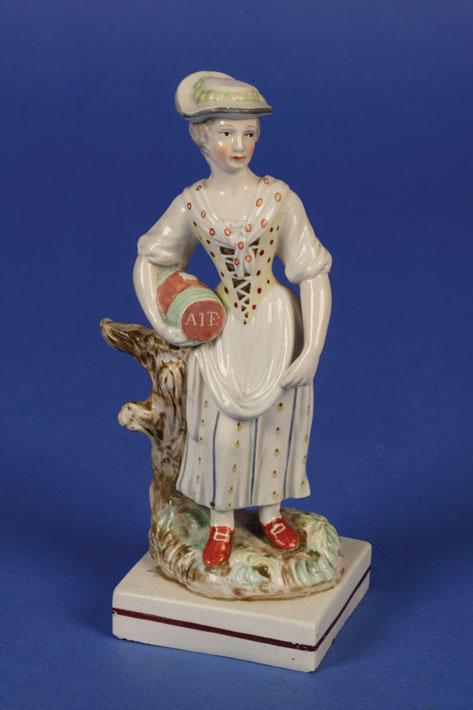 Appraisal: A STAFFORDSHIRE SQUARE BASE FIGURE OF A YOUNG GIRL holding