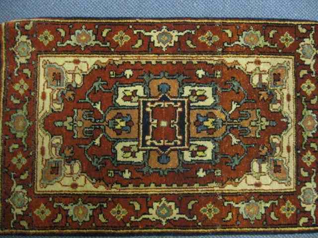 Appraisal: Serapi Persian Handmade Mat central geometric design red-brown field 'x