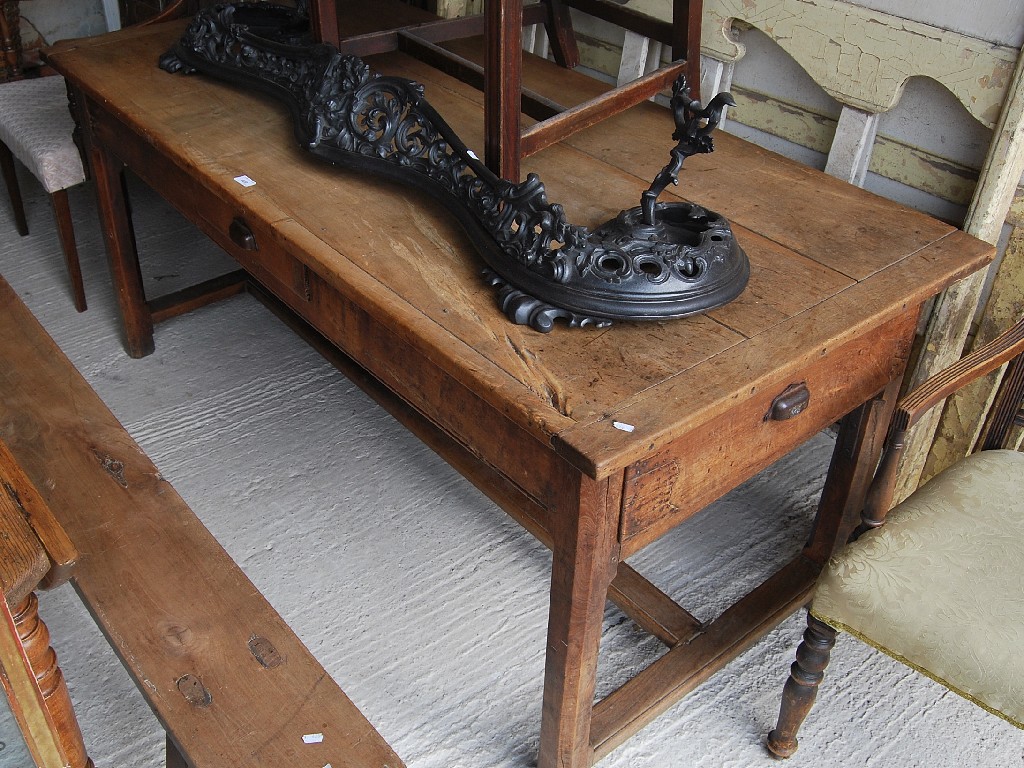 Appraisal: A th century French fruitwood kitchen table with cleated ends