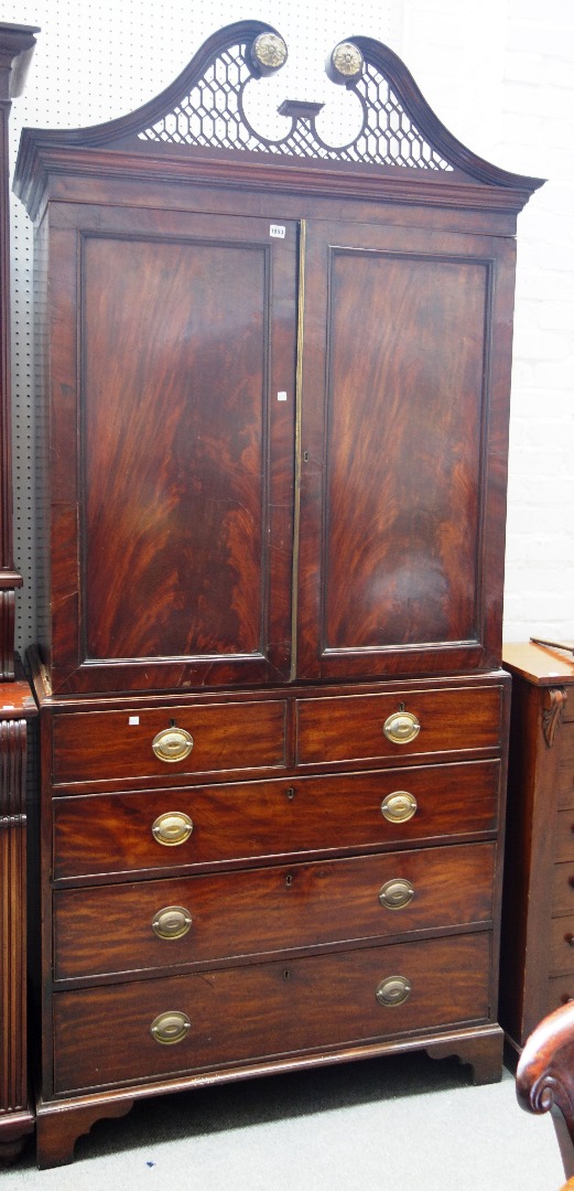 Appraisal: A George III mahogany linen press the pierced fret carved