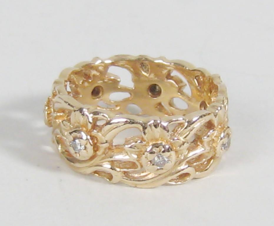 Appraisal: A Diamond pierced flower and foliate band Ring pav -set