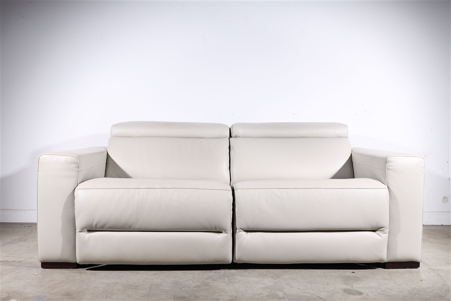 Appraisal: Eggshell leather vinyl two-seater sofa with armrest each seat measuring