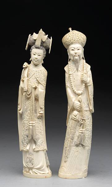 Appraisal: A pair of large carved and tinted ivory figures of