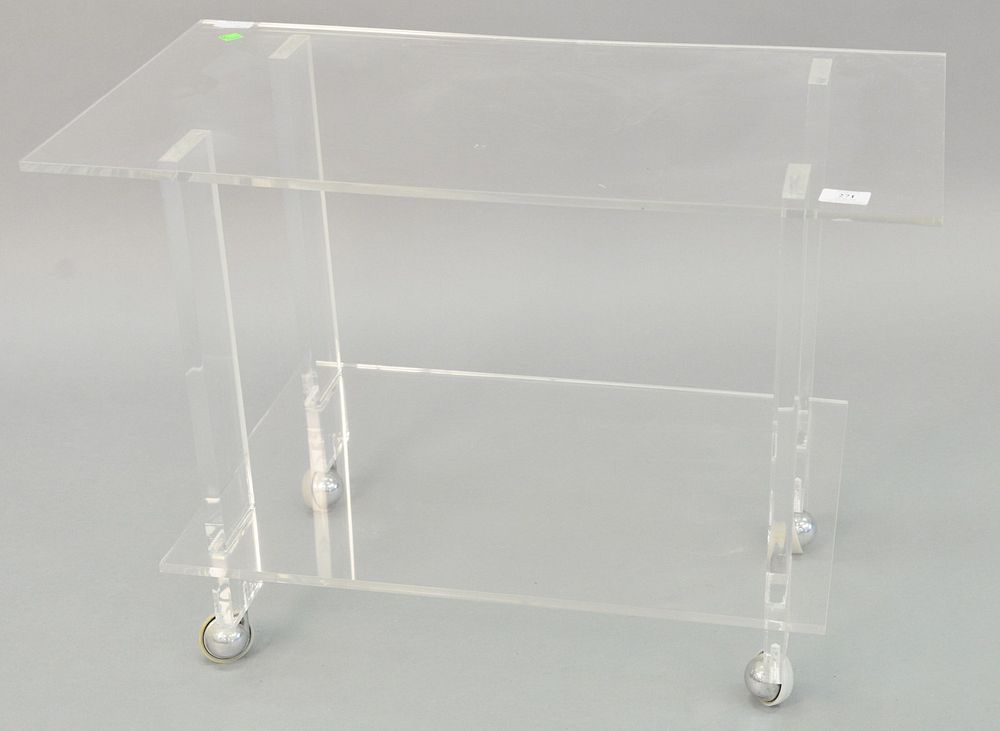 Appraisal: Contemporary lucite table two tiers on castor wheels light surface