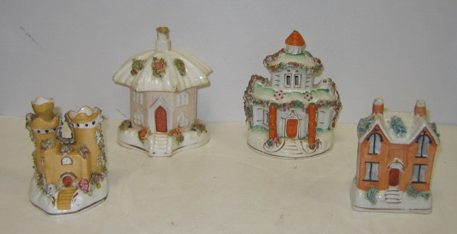 Appraisal: FOUR STAFFORDSHIRE CREAMWARE MINIATURE HOUSES Including cottage house two pastille