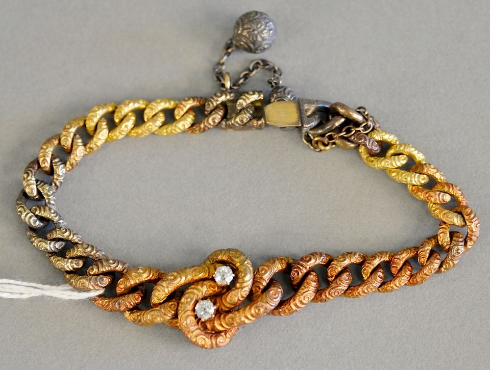 Appraisal: K tricolor gold bracelet designed with tapered carved links with