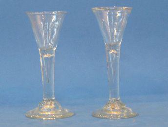 Appraisal: A PAIR OF GEORGE III STYLE WINE GLASSES with trumpet-shaped