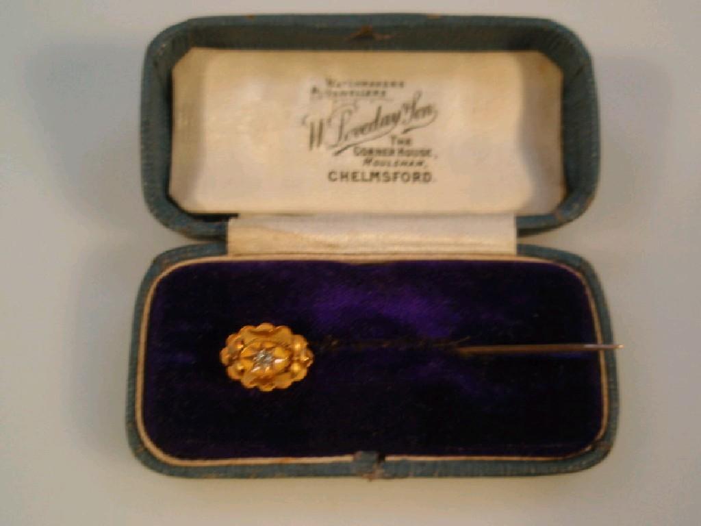 Appraisal: An Edwardian oval stick pin set with a small diamond