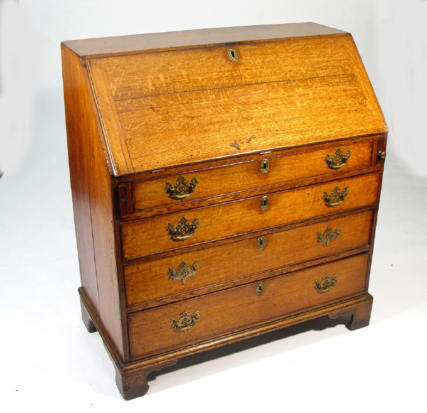 Appraisal: th Century oak bureau the fall above four graduated drawers