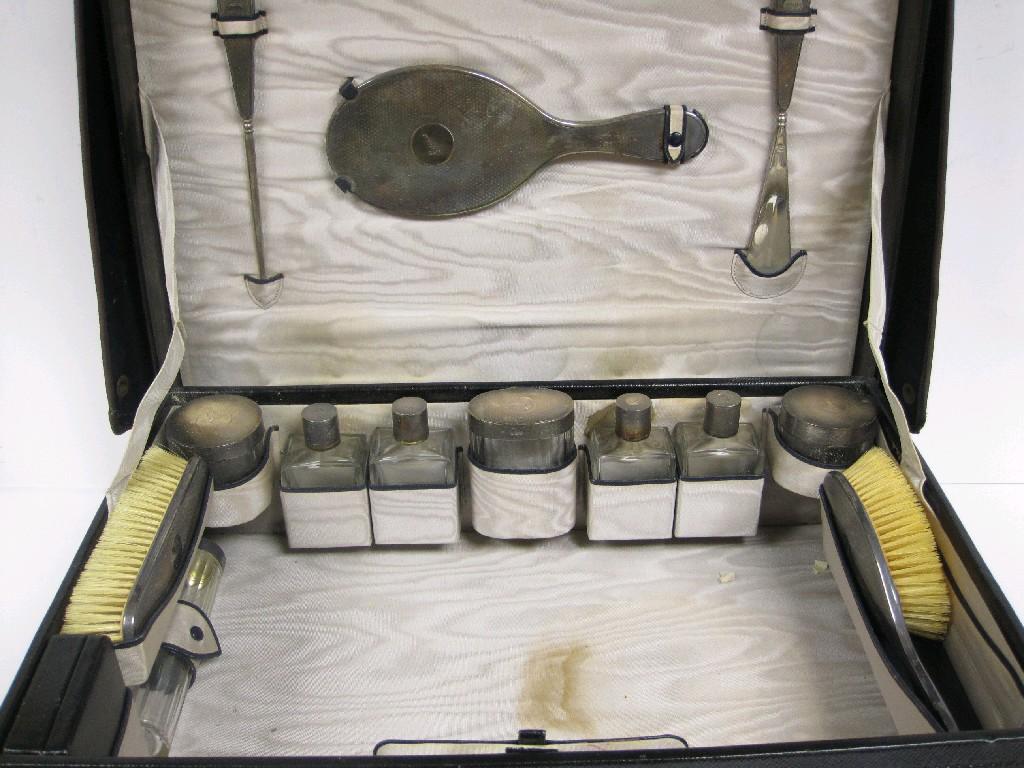 Appraisal: A George V leather Travelling Case containing silver mounted fittings