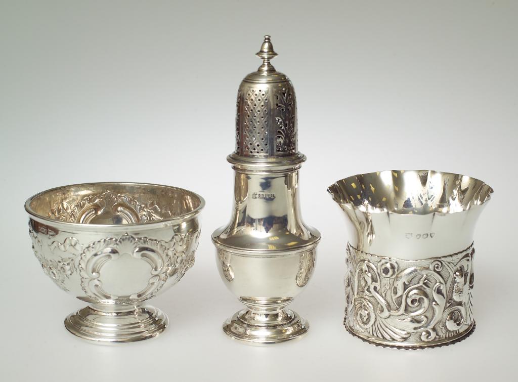 Appraisal: EDWARDIAN SILVER FOOTED BOWL Walker Hall Sheffield chased with C-scrolls