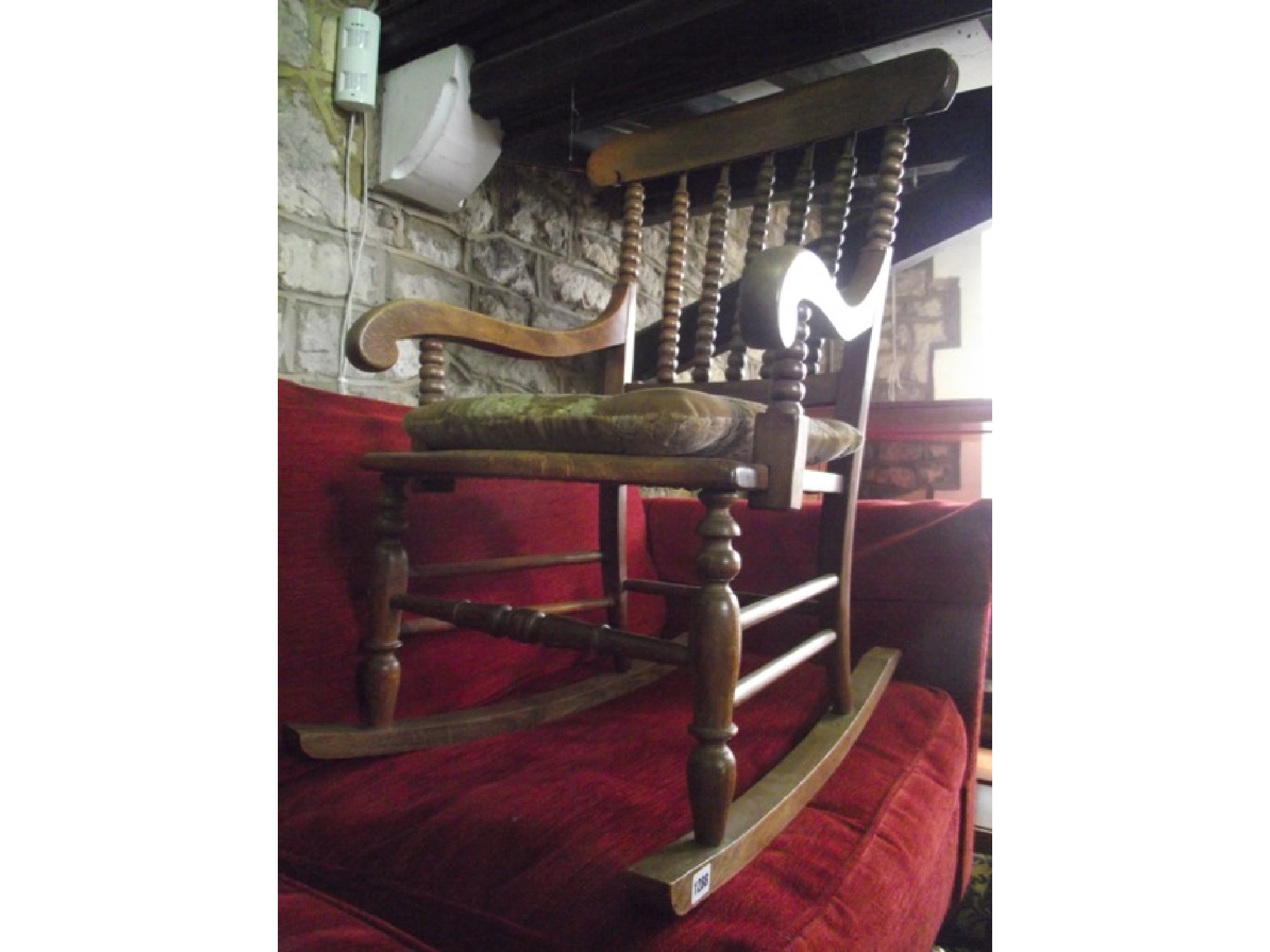 Appraisal: A late th century beechwood rocking chair with bobbin back