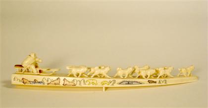 Appraisal: Scrimshaw-decorated and carved tusk A carved dog team and driver