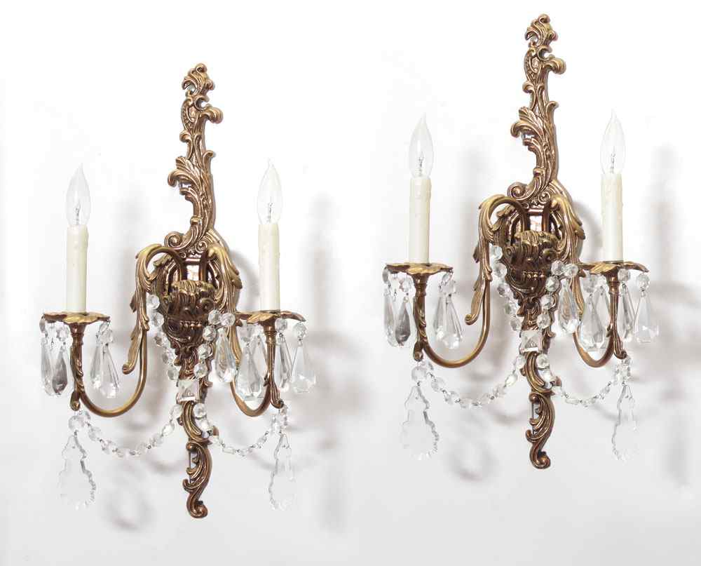 Appraisal: PAIR OF BRASS AND CRYSTAL WALL SCONCES Ornate foliate scroll