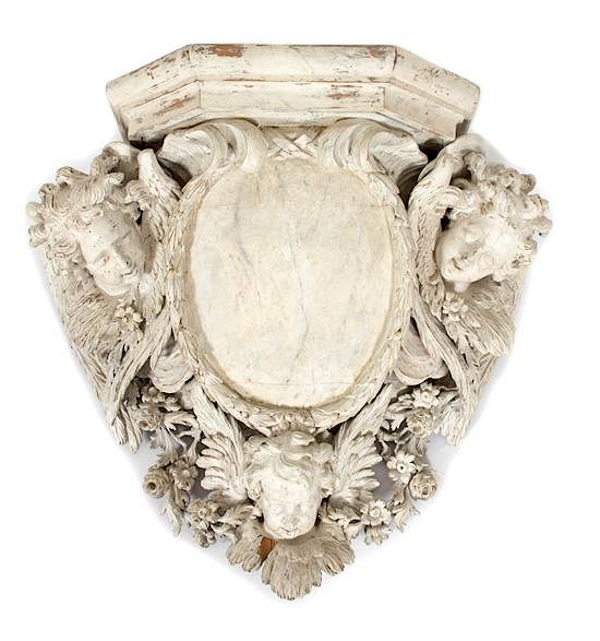 Appraisal: A Continental Carved and White Painted Armorial Wall Bracket Height