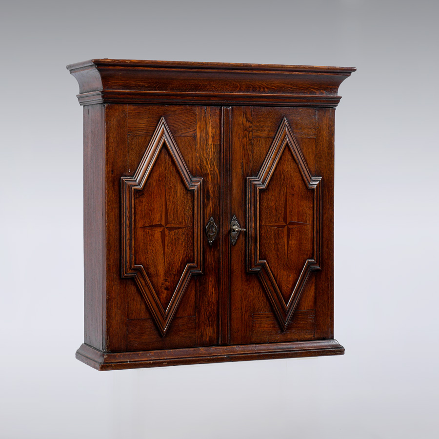 Appraisal: ENGLISH OAK DOOR HANGING CABINET Doors with applied decoration parquetry