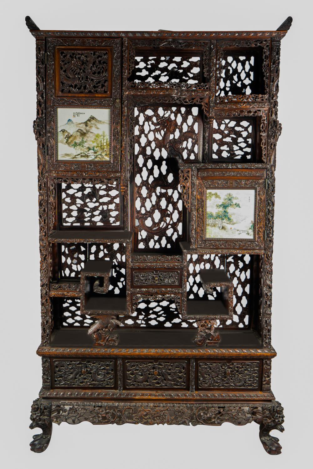 Appraisal: CHINESE CARVED HARDWOOD ETAGERE CABINETlate th Century with two porcelain-inset