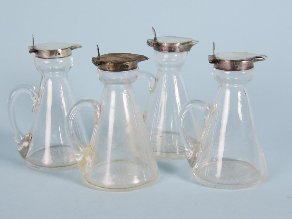 Appraisal: Four Edward VII silver lidded cut glass Toddy Bottles Birmingham