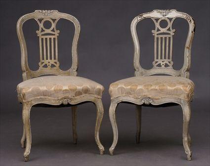 Appraisal: PAIR OF TRANSTIONAL-STYLE CARVED IVORY-PAINTED CHAISES EN CABRIOLET Each pierced