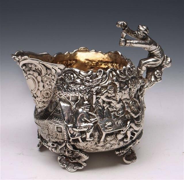 Appraisal: A GEORGE III SILVER CREAM JUG cast and depicting a