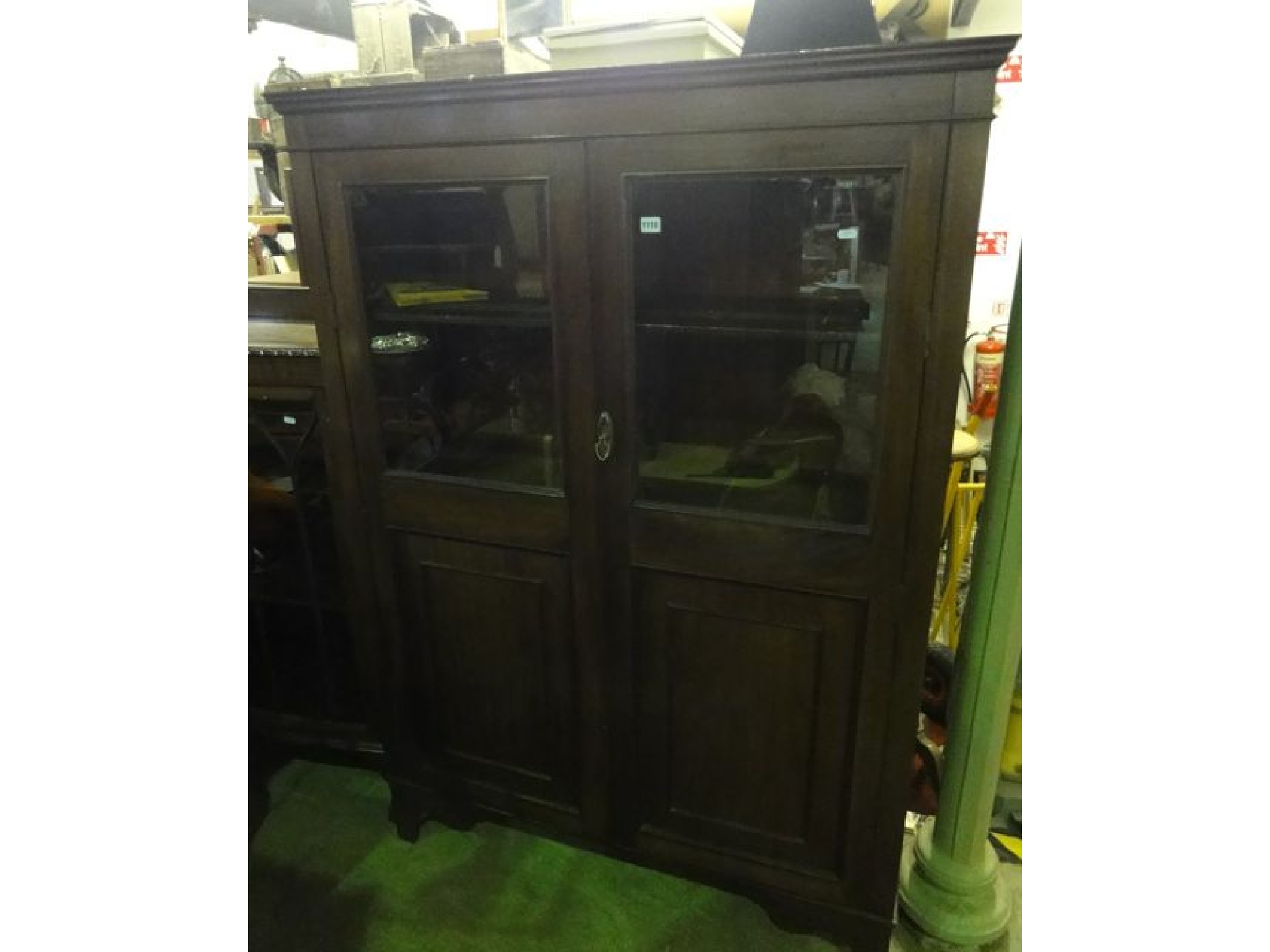 Appraisal: An Edwardian mahogany side cupboard enclosed by a pair of