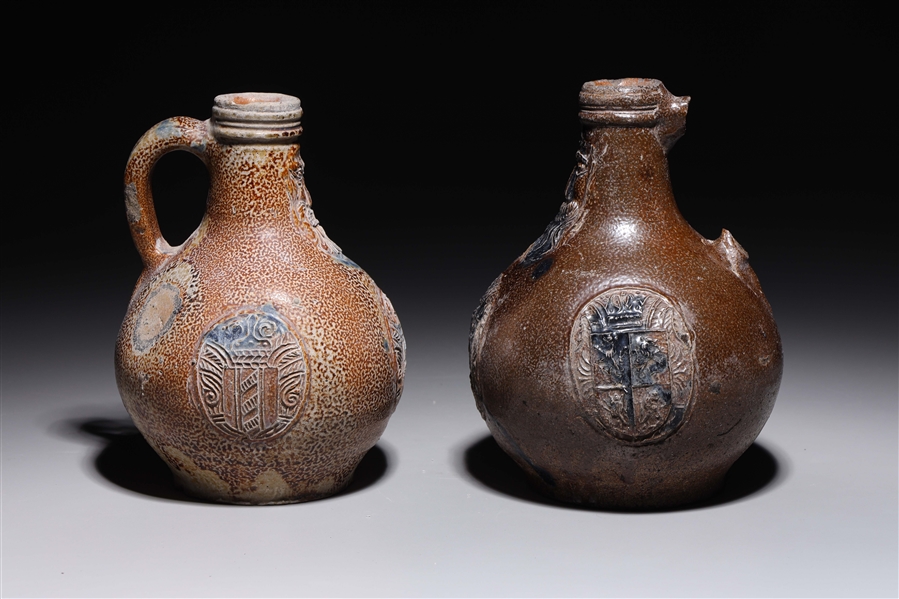 Appraisal: Two antique German bellarmine jugs with face and city mark