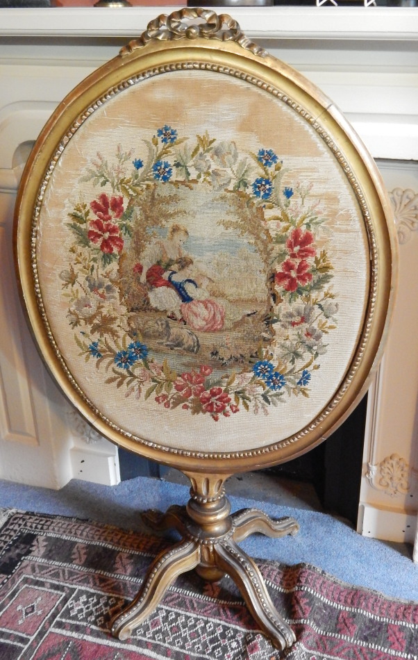 Appraisal: A thC giltwood and gesso fire screen the oval beaded