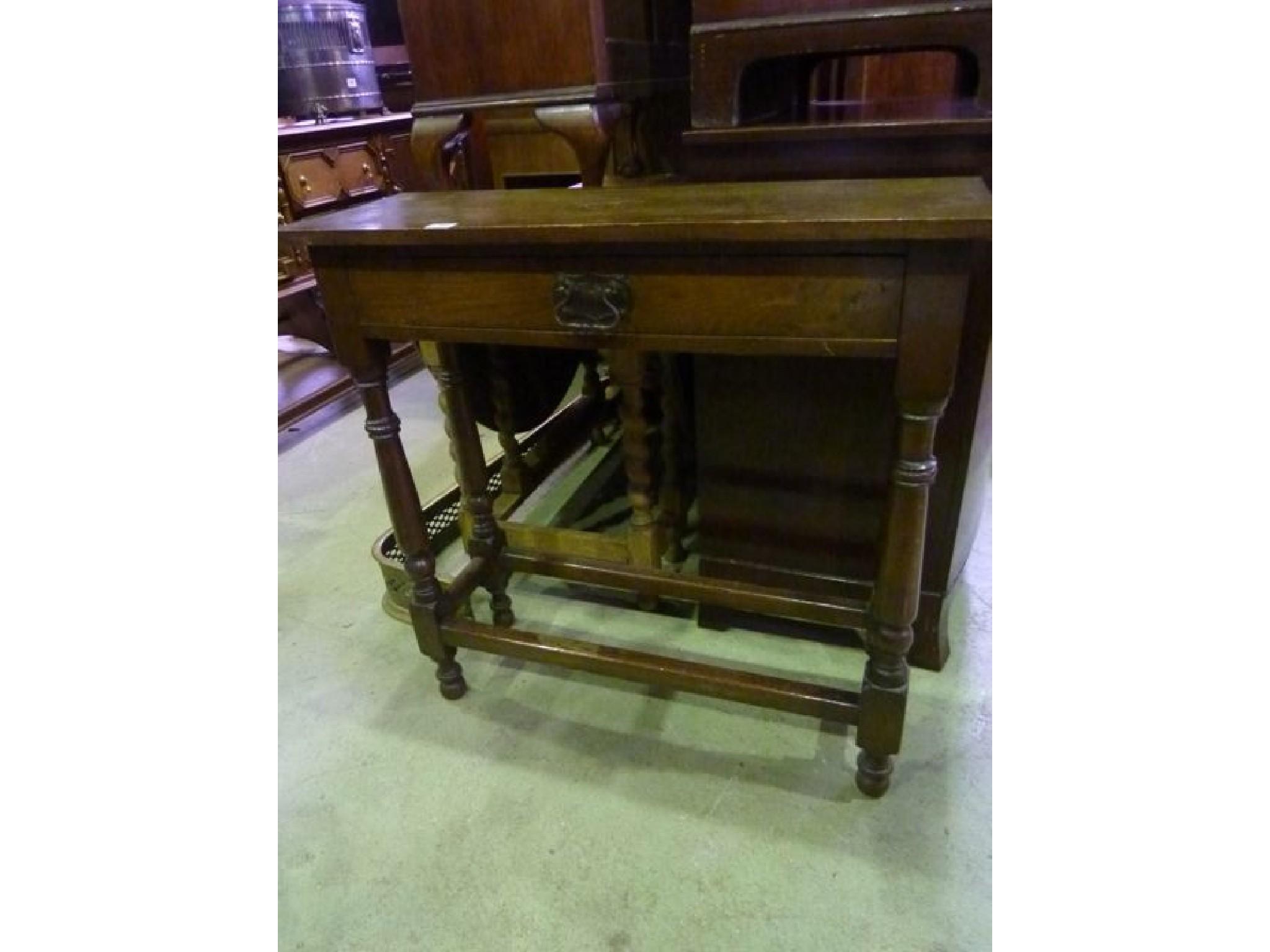 Appraisal: An oak hall table in the Old English style fitted