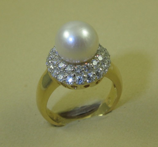 Appraisal: PEARL AND FOURTEEN KARAT GOLD RING centering a round white