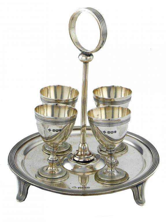 Appraisal: A VICTORIAN EGG-STAND with reeded ring handle and border the