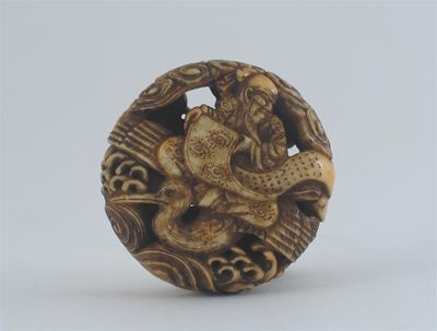 Appraisal: A Japanese ivory manju netsuke carved with an immortal riding