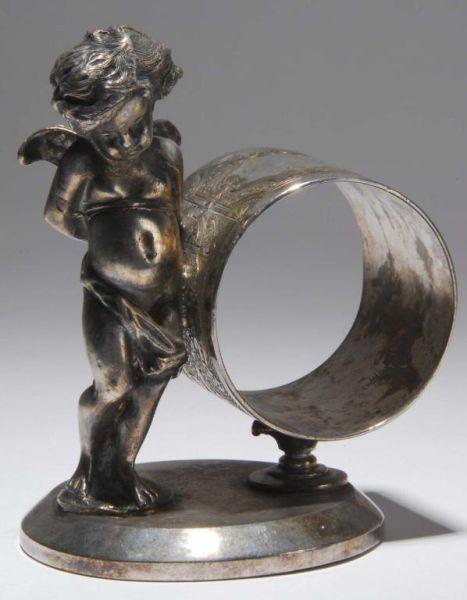 Appraisal: Bashful Winged Cherub Figural Napkin Ring Description Large bashful winged