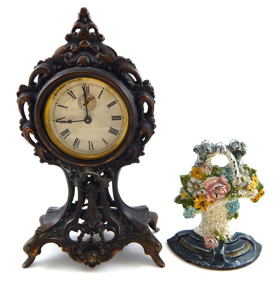 Appraisal: Two decorative arts including door stop and clock flower basket