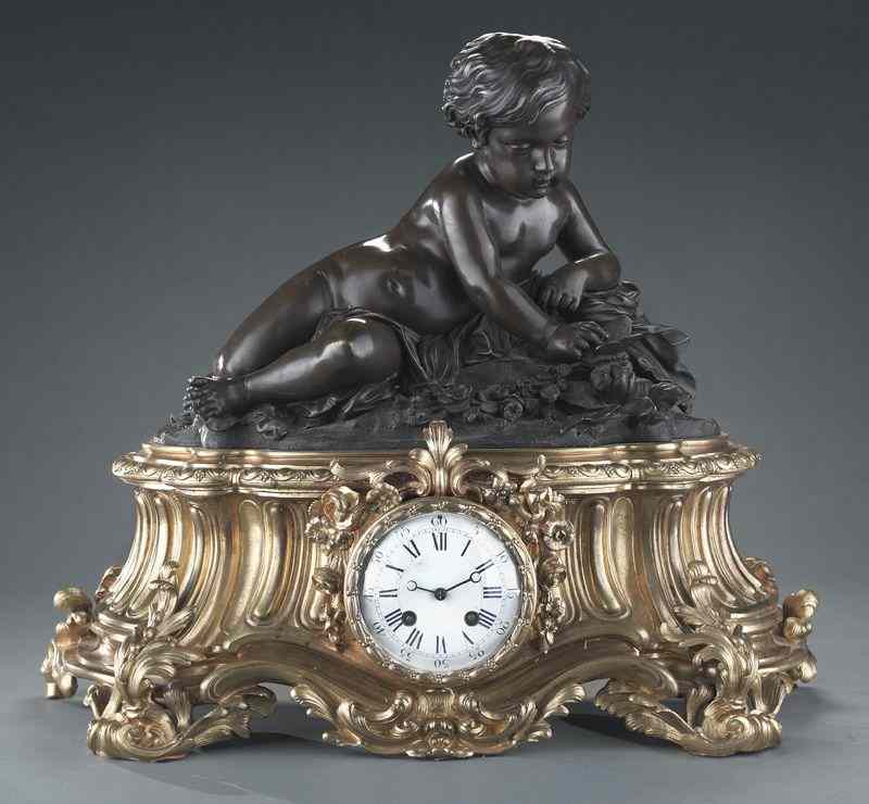 Appraisal: French gilt and patinated bronze figural clockdepicting a reclining putto