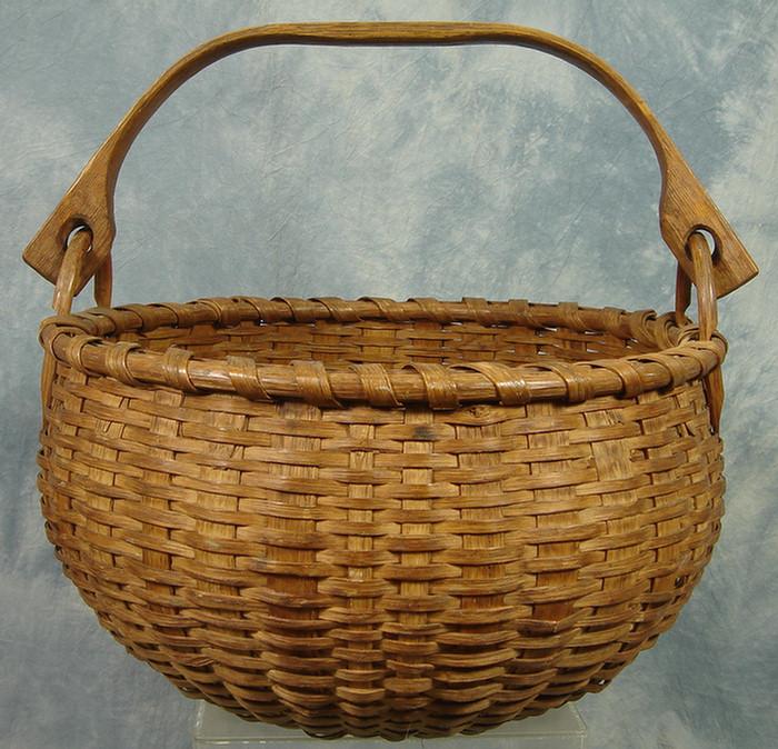 Appraisal: Round woven splint basket with oak swing handle rim minor