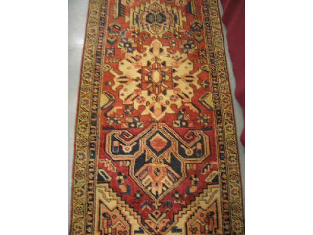 Appraisal: Heriz Persian Handmade Runner geometrics on reds blues ivory '