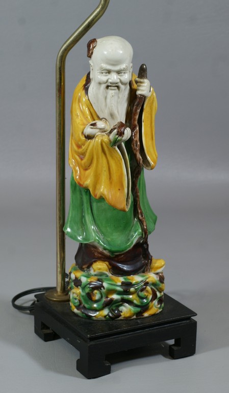 Appraisal: Chinese Pottery figure of an immortal holding a peach and