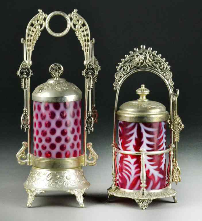 Appraisal: Fenton Cranberry Glass Pickle Jars CastorsTo include a silverplated cranberry