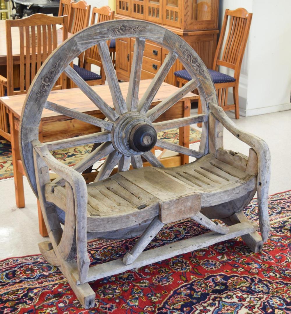 Appraisal: RUSTIC WAGON WHEEL BENCH the wood bench seat featuring a