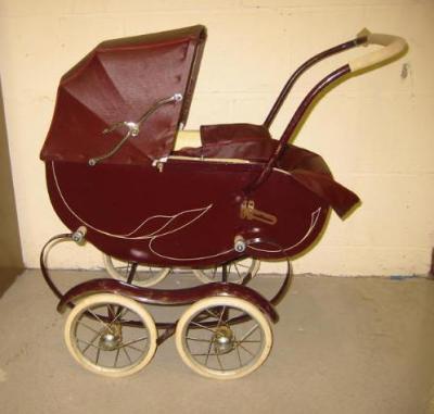 Appraisal: A Halsette doll's pram with maroon painted wood body applied