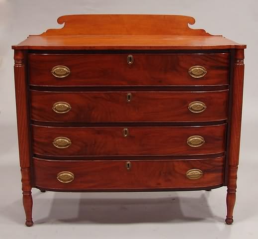 Appraisal: Walnut Shaped backsplash over four cockbeaded drawers flanked by turned