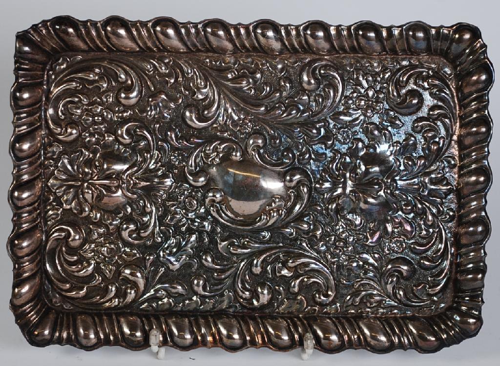 Appraisal: EDWARDIAN SILVER OBLONG TRINKET TRAY repousse with mask heads flowers