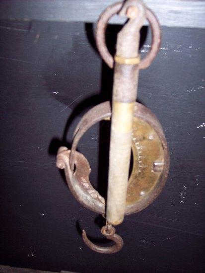 Appraisal: A wrought iron and brass hanging scale and another scale